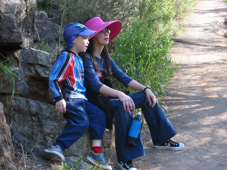 Michael and Theen rest on a rock