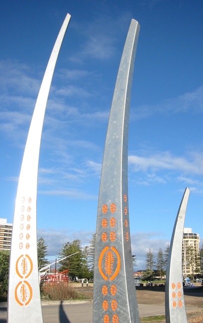 Three curved metal shafts point skyward