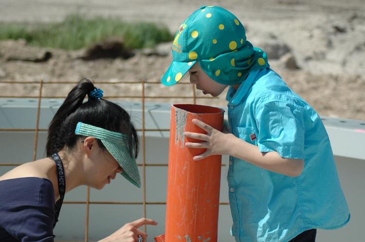 Theen and Michael at the construction site of a wind generator tower