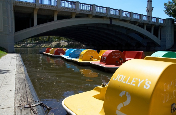 Colourful paddle-boats moored on the river