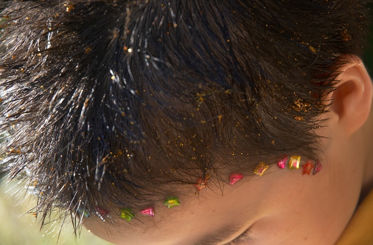 Closeup of michael's hair done up with glitter and stickers