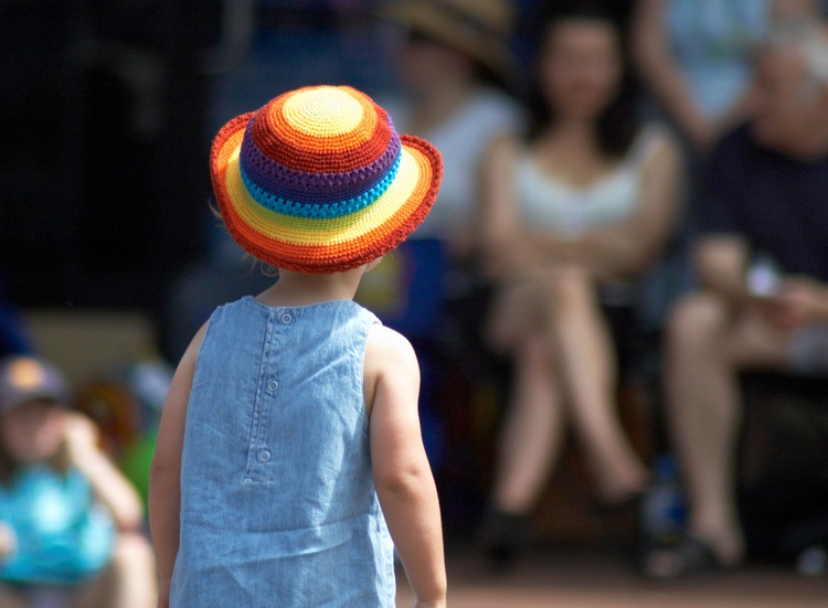 Small child in a brightly coloured hat