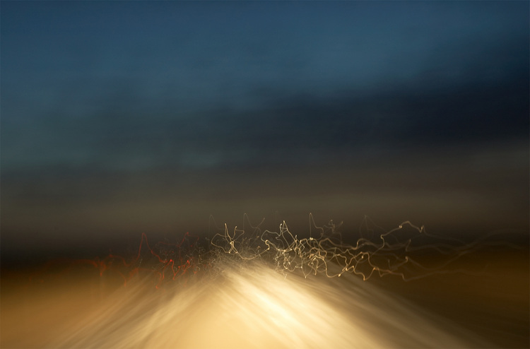 An abstract pattern of headlights and tail-lights