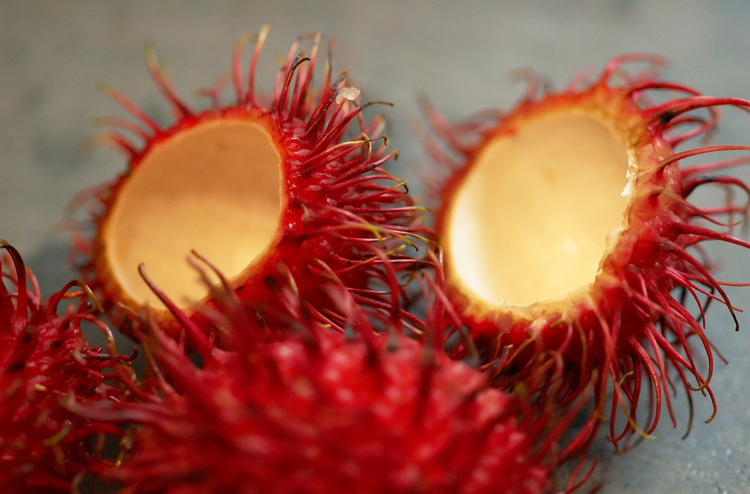 Rambutan fruit, whole and halved