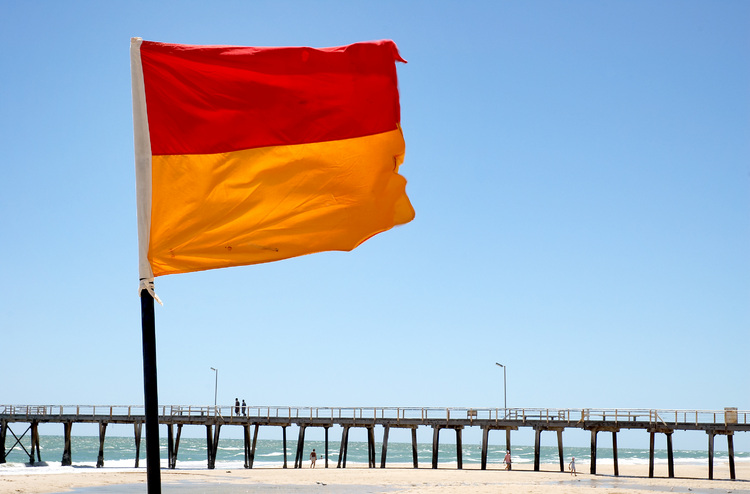 A flag in the foreground of a jetty