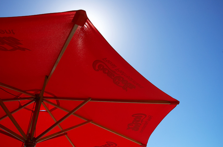 A red umbrella against a blue sky