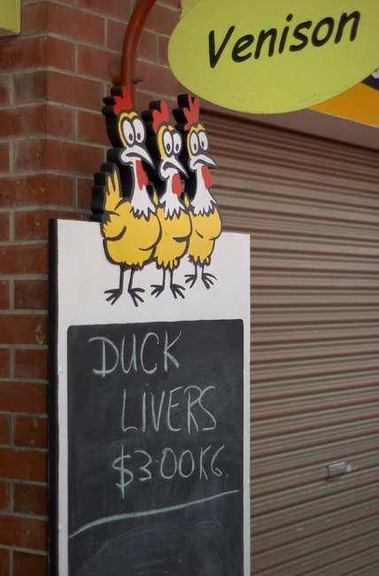 Sign reading 'Duck Livers', with a 'Venison' sign above it