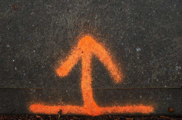 An orange spray-painted arrow