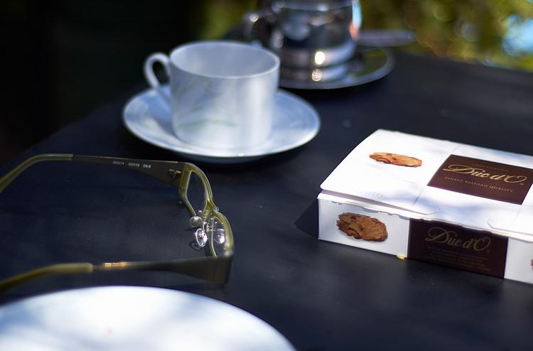 Reading glasses, coffee cups, and a chocolate box