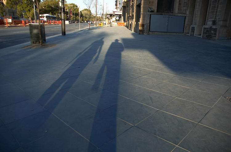 Long shadows of pedestrians