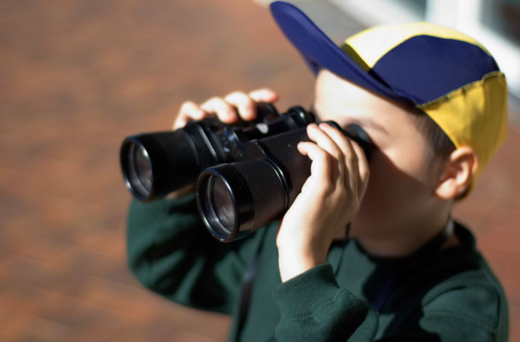 Michael with binoculars to his eyes