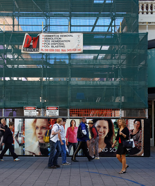 People pass by a demolition site in Rundle Mall