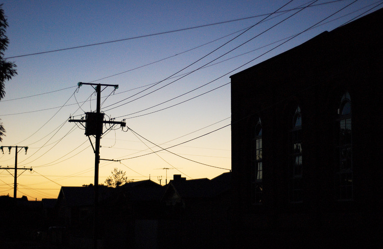 Buildings silhouetted against a dusk sky