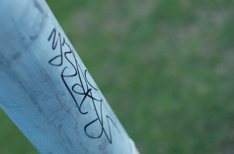 A small graffiti tag on a light pole