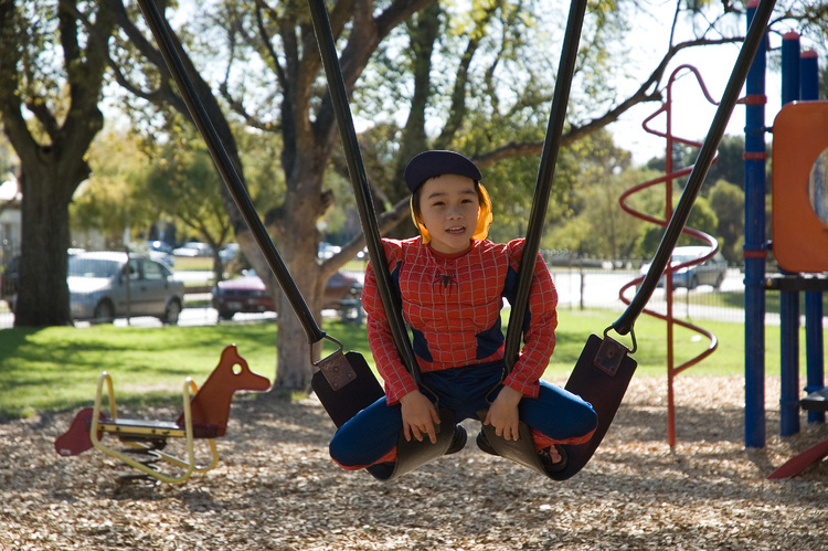 Michael sits on two swings at once