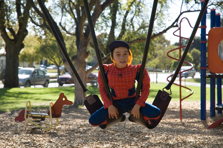 Michael sits on two swings at once