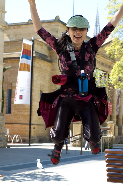 Theen in mid-air, jumping from a low wall