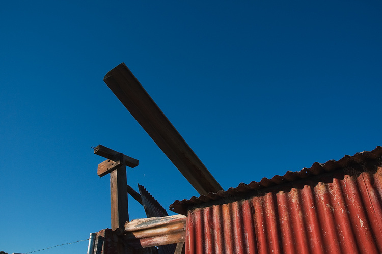 Corrugated iron, against a blue sky