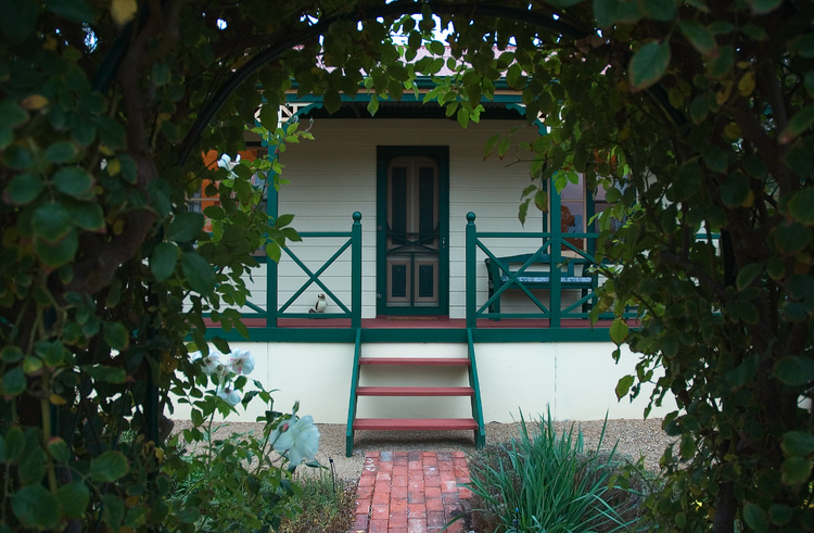 Looking through the rose arch at Meander Cottage