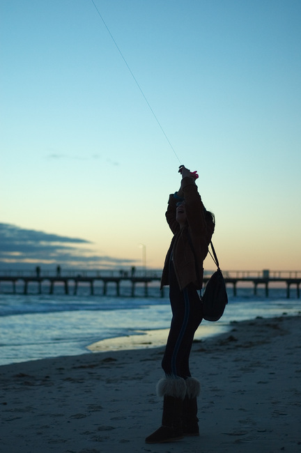 Theen flying a kite at the beach