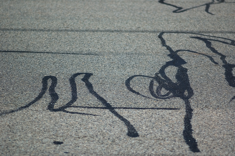 Squiggles of tar on a road surface