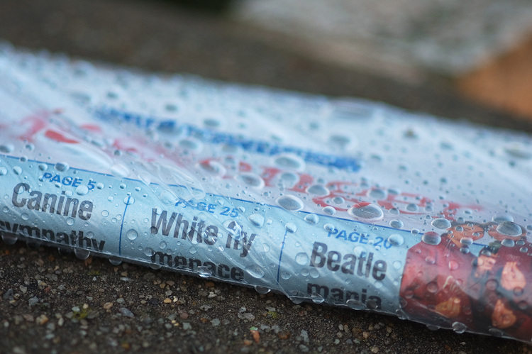 Closeup of a newspaper wrapped in wet plastic