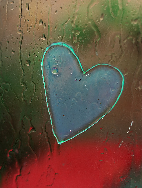 Rain drops and a heart-shaped sticky thing on a window