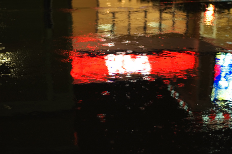 Bright signs, reflected in puddles