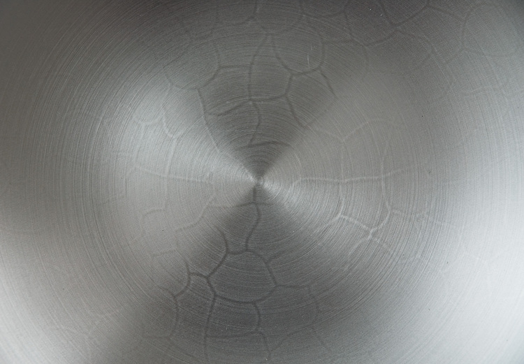 The base of a pristine wok, with a crazed pattern showing through