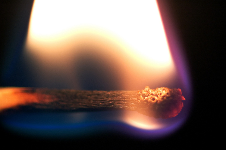 A closeup of a burning match
