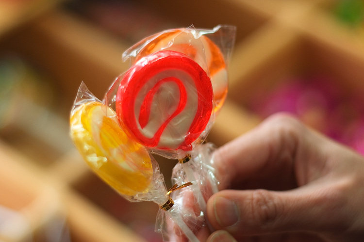 Three lollipops being held by a hand