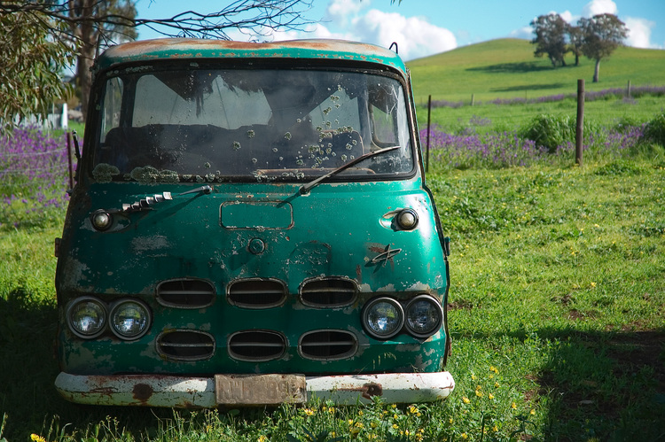 An old van abandoned in the corner of a paddock