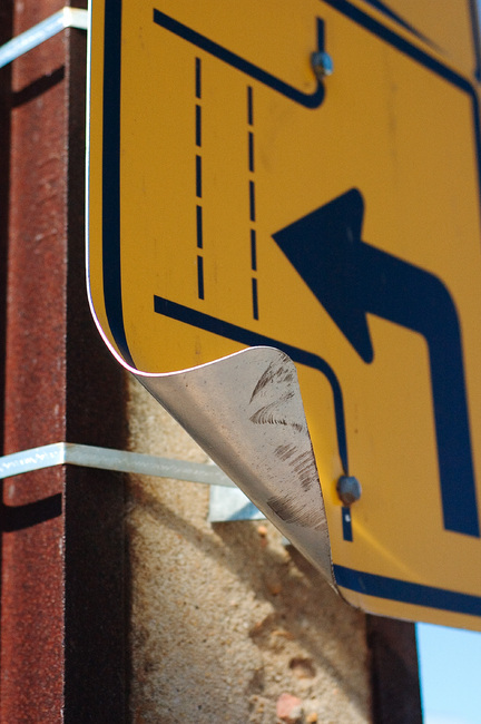 A bent road sign