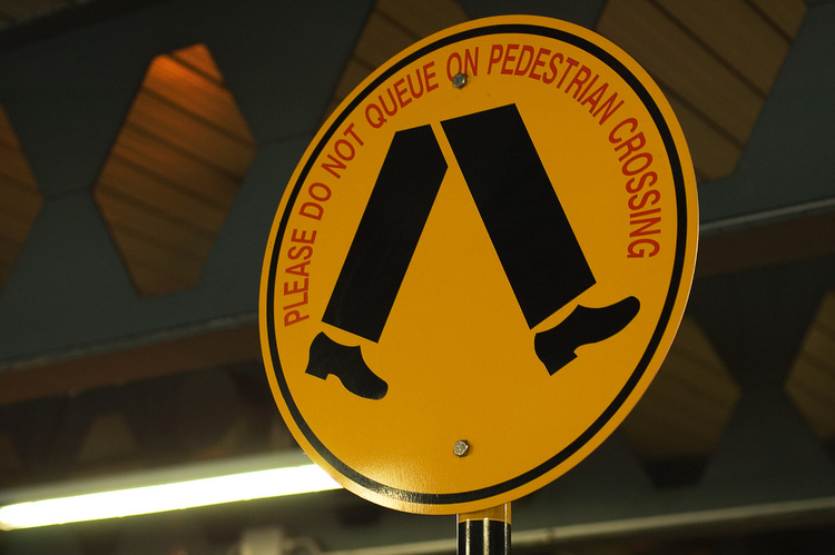 A yellow pedestrian sign