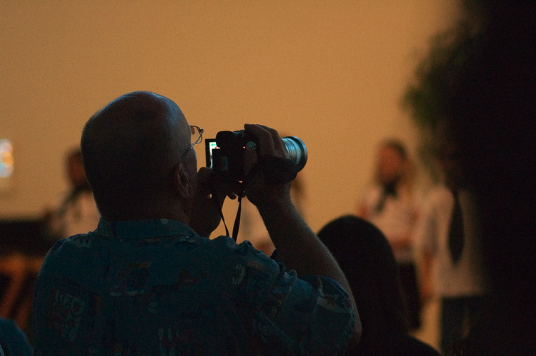 A man recording a school concert