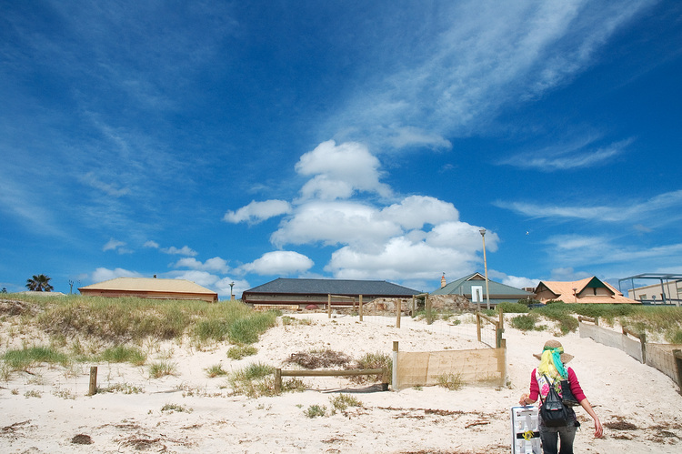 Sand dunes, and clouds in a bright blue sky