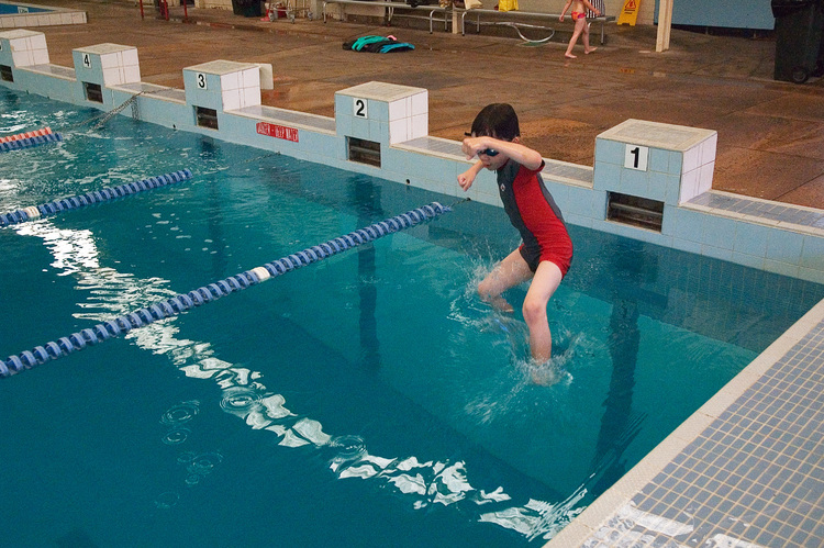 Michael, jumping into a swimming pool