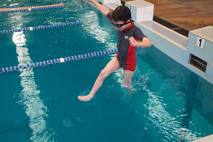 Michael, jumping into a swimming pool