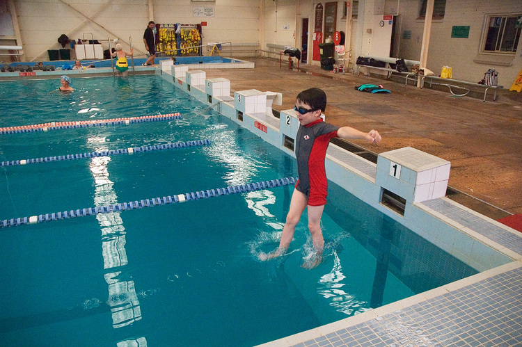 Michael, jumping into a swimming pool