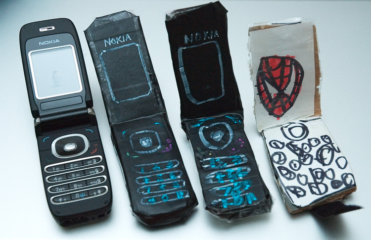 Three replica mobile phones, and one real one