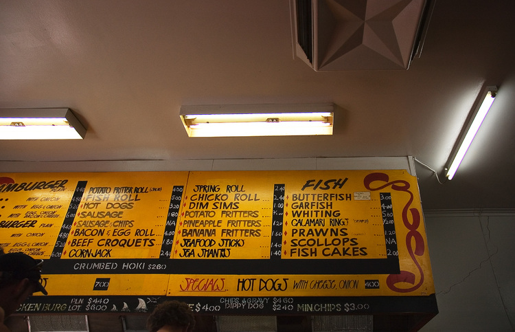 The price board at a fish and chip shop