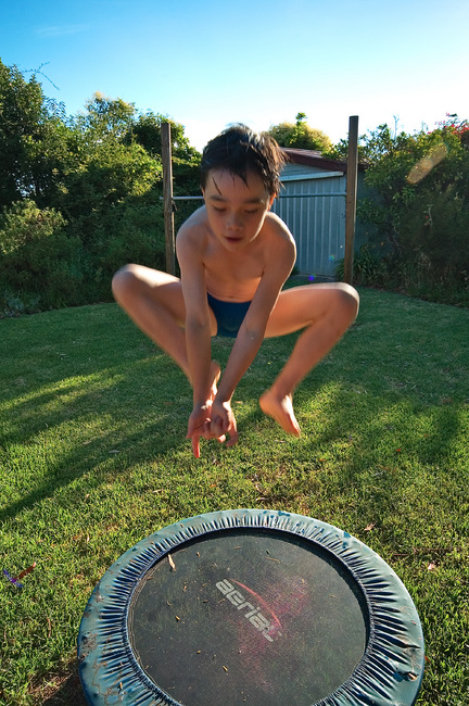 Michael posing as Spider-Man, while jumping on a trampoline