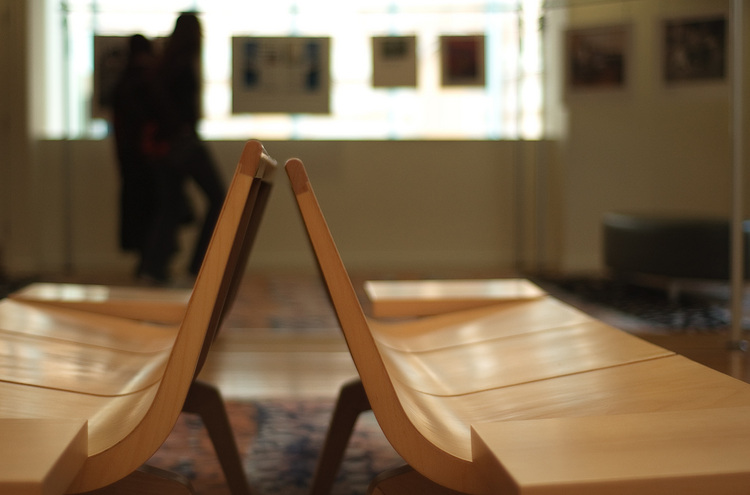 An end-on view of a pair of wooden benches