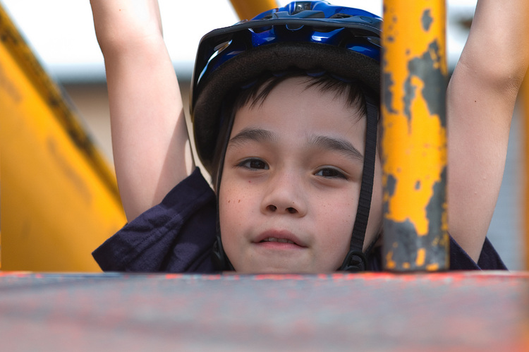 Michael hanging from playground equipment