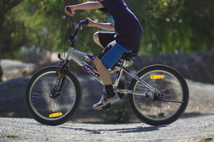 Michael riding his bike, with his head cropped from the picture