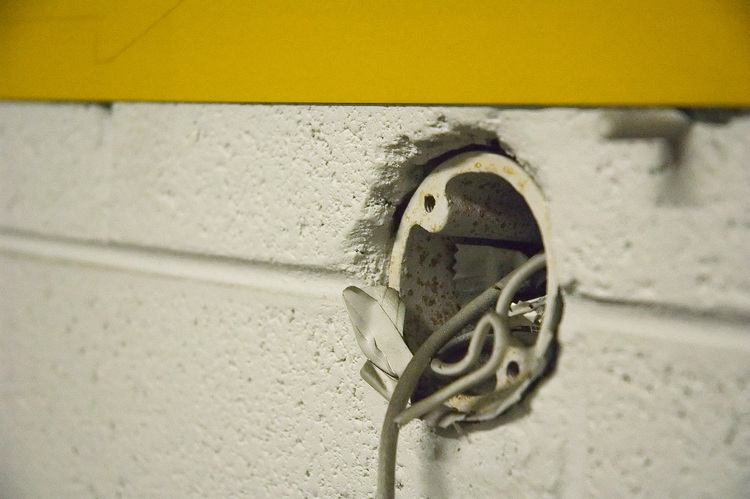 Closeup of an old electrical conduit in a brick wall