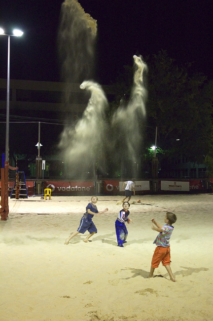 Michael throwing fireworks-like cups of sand into the sky