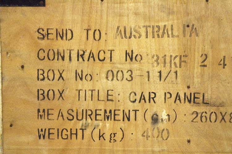 Stencilled lettering on the side of a wooden box