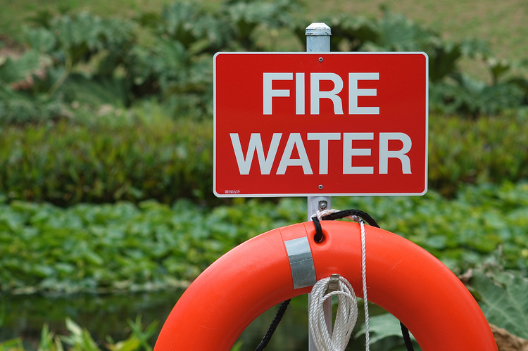 A life buoy, below a sign reading 'fire water'