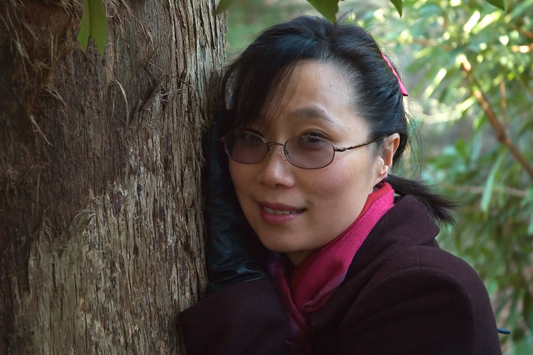 Theen resting against a tree